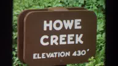 Washington (1964): A Sign Reading Howe Creek Elevation With Green Foliage In The