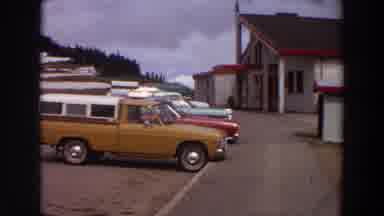 Washington (1964): View Of Orange Truck Parked By White Building On A Cloudy Day