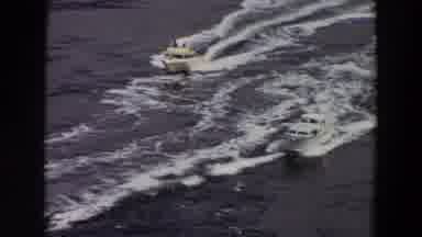 Washington (1964): Two Speed Boats Racing Through A Large Body Of Water