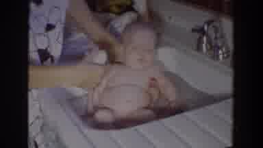 FALLSTON MARYLAND-1965: A Woman Bathes A Baby In A Sink Using A Washcloth And