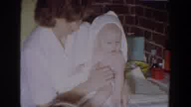 Fallston Maryland (1965): Woman Wearing White Shirt Wraps And Dries Baby With