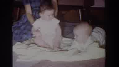 Fallston Maryland (1965): Woman Wearing Blue Dress Helps Baby Wearing White Shirt