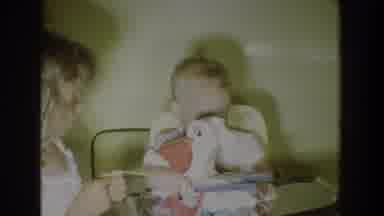 Fallston Maryland (1965): A Baby Sitting In A Highchair While Another Child Plays