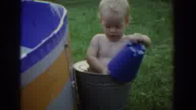 Fallston Maryland (1965): A Blonde Haired Baby Sits In A Bucket Of Water Happily