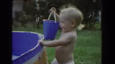 Fallston Maryland (1965): Smiling Blond Toddler In A Metal Bucket Carries A Blue