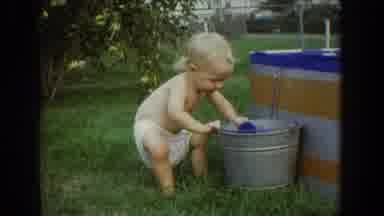 Fallston Maryland (1965): Child Playing Getting Into A Bucket Of Water On A Lawn