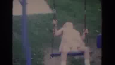 Fallston Maryland (1965): Girl Wearing White Romper Swings On Swing-set On A Clear