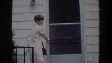 Fallston Maryland (1965): A Woman With Short Hair Wearing A Day Dress Exits Her