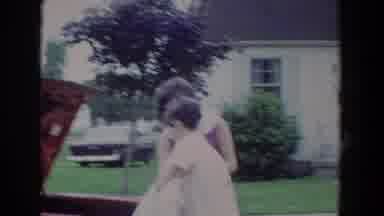 Fallston Maryland (1965): Two People With Short Hair Put A Dress In The Back Of A
