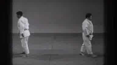 Tokyo Japan (1971): Men Wearing White Karate Uniforms Stand On Grey Floor Mat