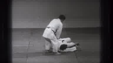 Tokyo Japan (1971): Man Wearing White Karate Uniform Flips Person Onto Grey Floor