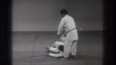 Tokyo Japan (1971): Two Men Practicing Martial Arts Moves While One Lays On The