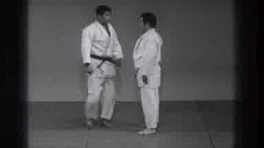 Tokyo Japan (1971): Two Men Wearing Do Gus Face Each Other Raise Arms To Each