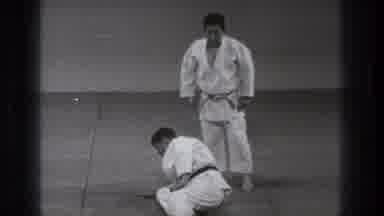 Tokyo Japan (1971): Two Men Practicing Judo On Mat One Gets Off The Ground