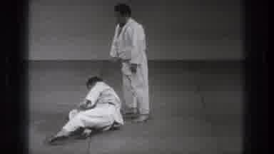 Tokyo Japan (1971): Man Wearing Karate Uniform Gets Up From Grey Floor Mat