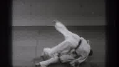 Tokyo Japan (1971): A Martial Artist Falls To The Mat And Throws Another Over His