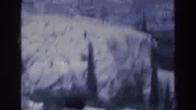 ATHENS GREECE-1976: Man Stands on Acropolis Cliff Overlooking City