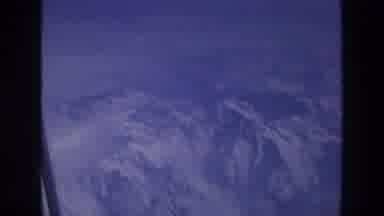ATHENS GREECE-1976: Aerial View of Snow-Covered Mountains from Airplane Window