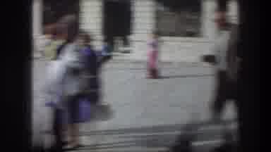 Bethlehem Israel (1976): Woman Wearing Yellow Suit Walks Across White Stone