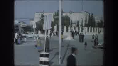 Bethlehem Israel (1976): People Walking Towards White Building On A Clear Sunny