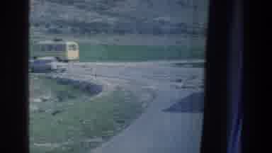 Israel a (1976): A Car And A Bus Passing By On A Road Full Of Rocks
