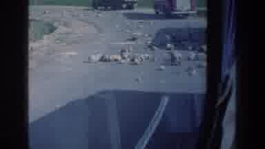 Israel a (1976): A Car Driving Past Rocks On The Street And A Rocky Landscape