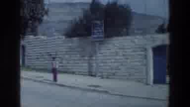 Israel A-1976: Person Walking Along Stone Wall Near Blue Door