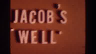 Israel A-1976: Jacob's Well Sign and Crowd Outside