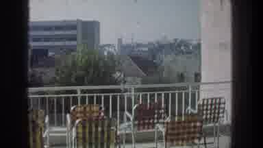 Jerusalem Israel (1976): Camera On A Balcony Full Of Lawn Chairs Zooming Into A
