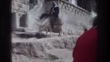 Jerusalem Israel (1976): Man Getting Off Of Donkey While People Walk Past Him