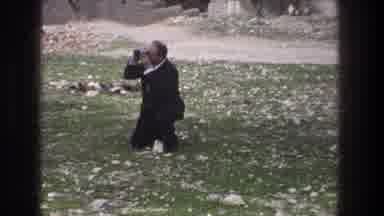 Jerusalem Israel (1976): Man Crouching On The Grass Concentrated Taking Picture Of