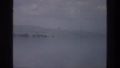 Sea of Galilee Israel (1976): A Large Body Of Water Covered In Mist And Fog Where