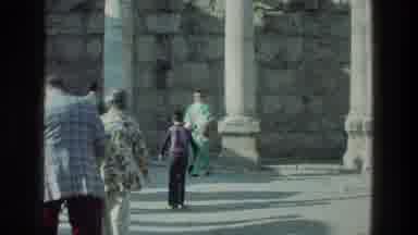 Sea of Galilee Israel (1976): People Walking Towards White Stone Wall On A Sunny