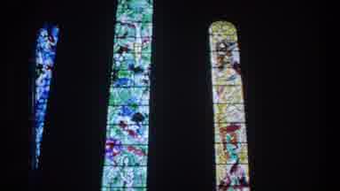ZURICH SWITZERLAND-1976: Stained Glass Windows Lit From Behind in Dark Church Interior