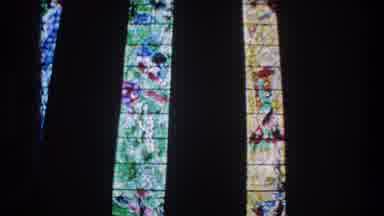 ZURICH SWITZERLAND-1976: Camera Recording Stained Glass Panels From Inside Church