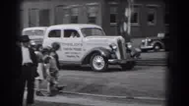 Reading Pennsylvania (1938): Several White Cars Driving On Road Past People And