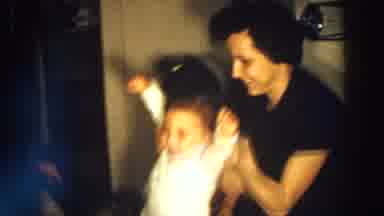 Aliquippa Pennsylvania (1958): A Woman Picks Up And Puts A Blue Hat On A Child