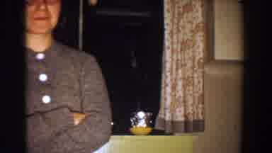 Aliquippa Pennsylvania (1958): Woman Wearing Glasses Sweater Speaks Inside Dark