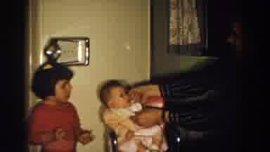 Aliquippa Pennsylvania (1958): Infant In A Highchair Having A Bib Removed By An