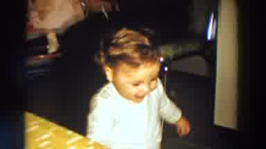 Aliquippa Pennsylvania (1958): Toddler Wearing White Shirt Walks Past Yellow Table