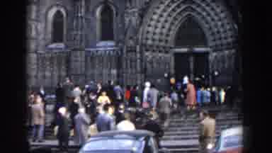 Barcelona Spain-1959: Old Time Video Of Many People Walking Into A Large Cathedral