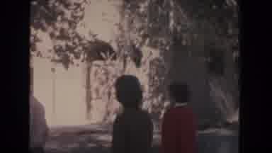 New Mexico-1951: People On A Walk To The Tall White Building