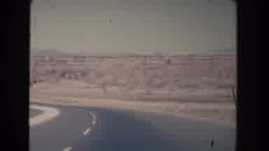 New Mexico (1951): Vehicle Passing Through Isolated Highway In The Valley