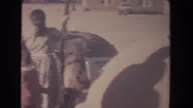 New Mexico (1951): Family Around Bread Basket While Mother Selects Bread