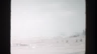 Grand Rapids Michigan (1956): Man Wearing Red Hat Waves From Blue Car On A Sunny