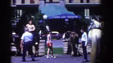 French Lick Indiana (1958): People Gathered On The Street On Horseback With House