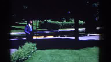 French Lick Indiana (1958): Man Walks Into An Outdoor Event As Cars Drive Pass