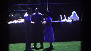 French Lick Indiana (1958): Woman Wearing White Dress Waves At Camera On A Bright