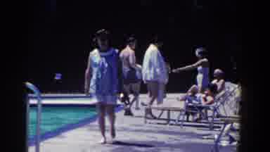 French Lick Indiana (1958): Woman Wearing Blue Blouse Walks Past Pool On A Sunny