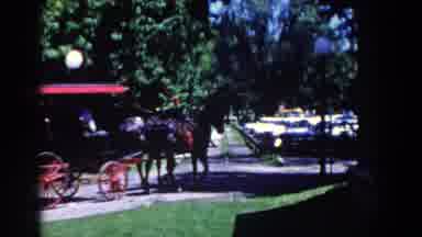 French Lick Indiana (1958): Two Horses Are Pulling A Buggy Down A Short Street
